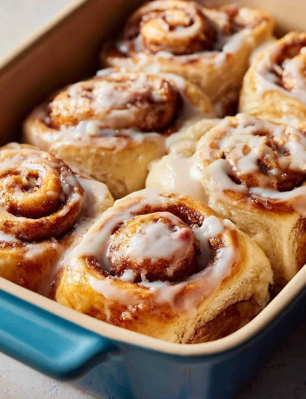 Delicious banana bread cinnamon rolls topped with icing and cinnamon