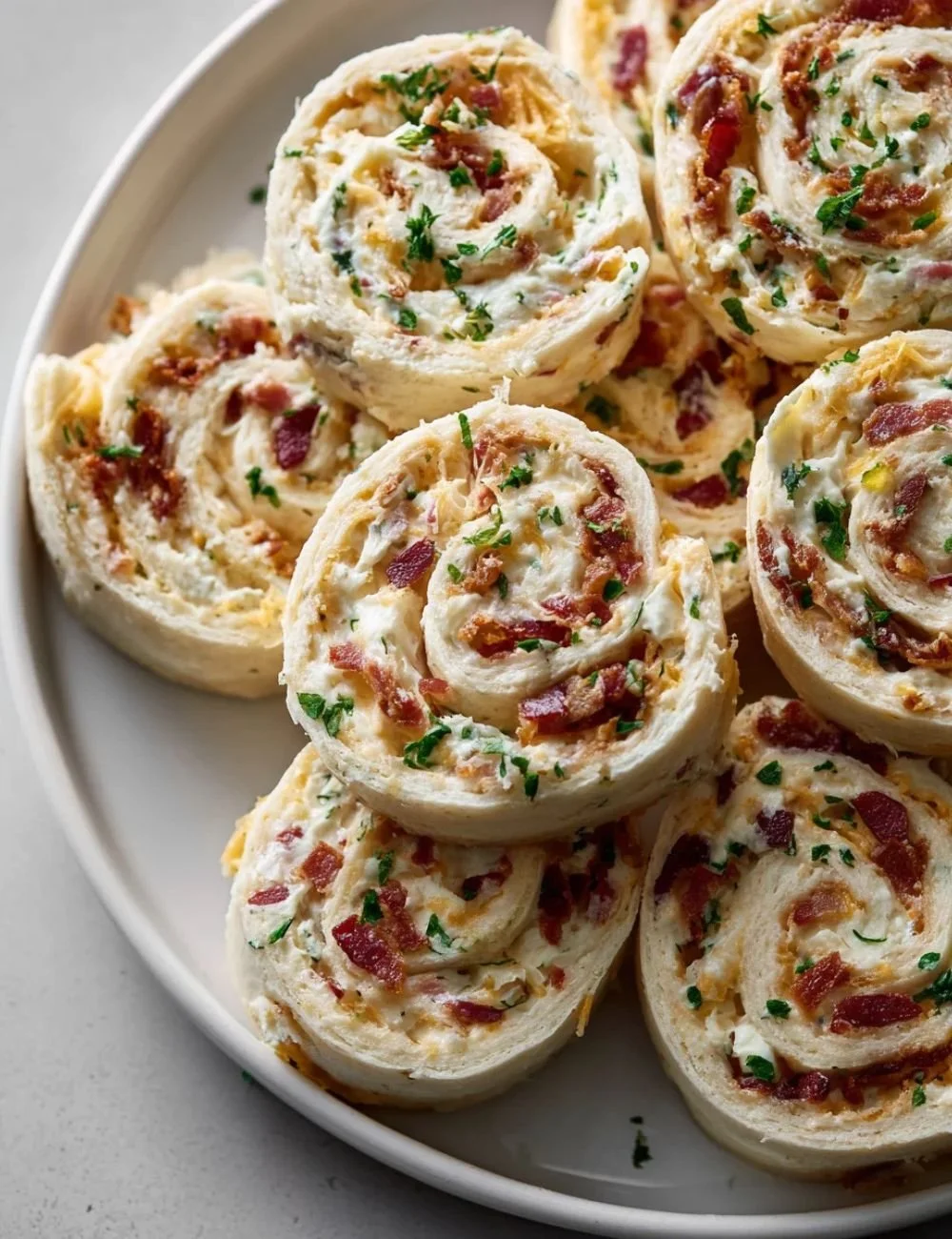 Cheddar Beef Bacon Ranch Pinwheels served on a platter, a savory snack option.
