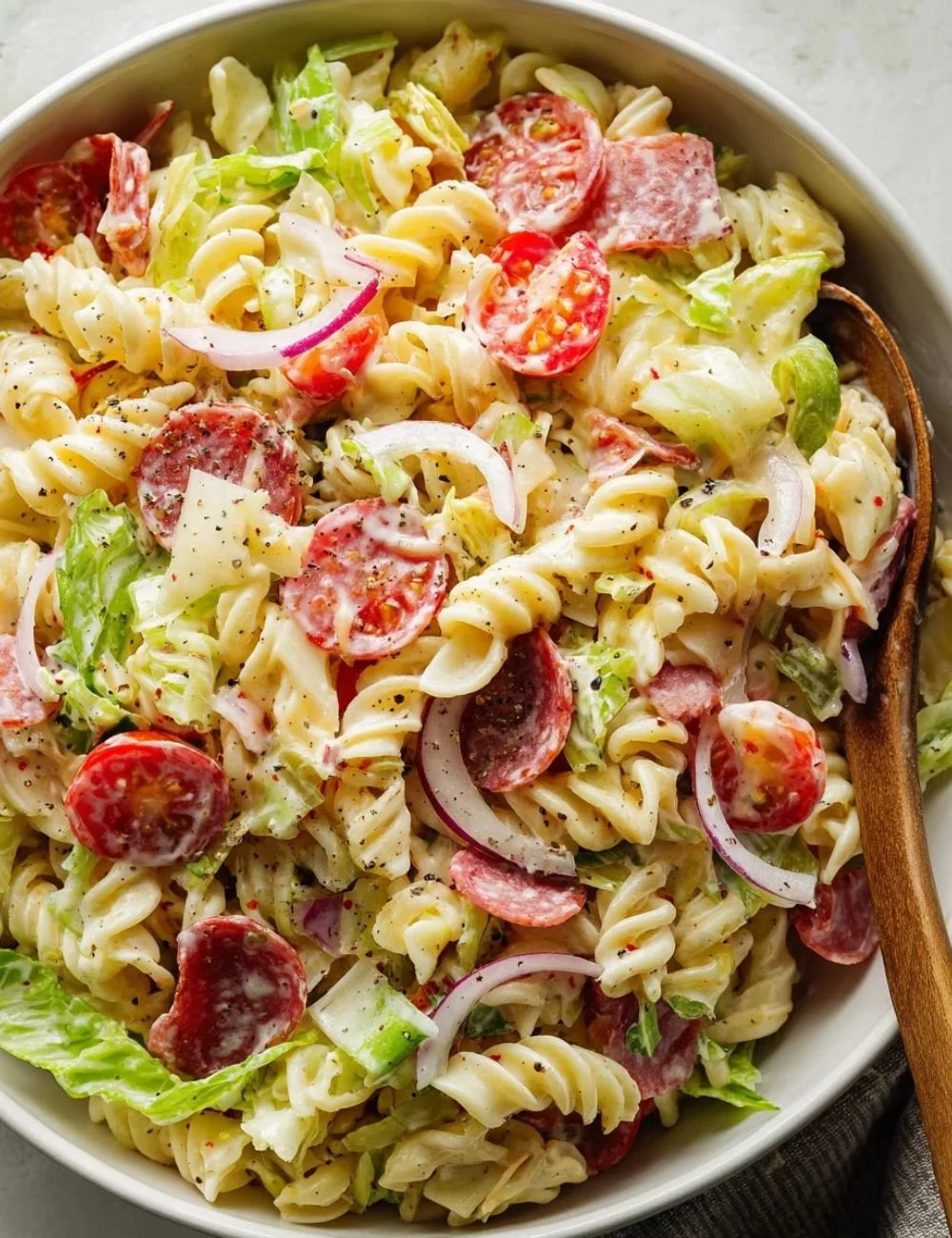 Delicious Grinder Pasta Salad served in a bowl with fresh vegetables and dressing