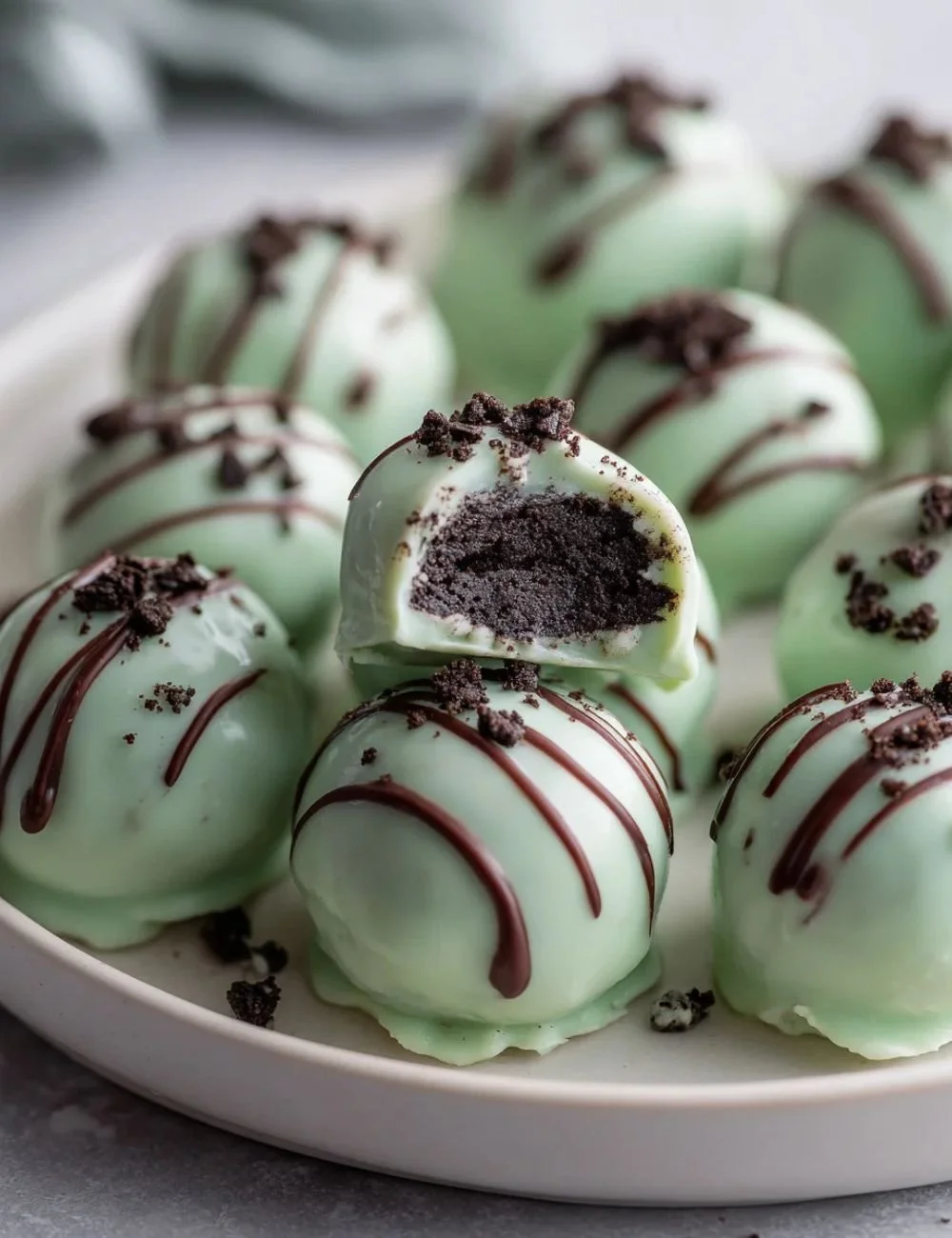 Delicious Mint Oreo Truffles topped with crushed Oreos and mint sprinkles