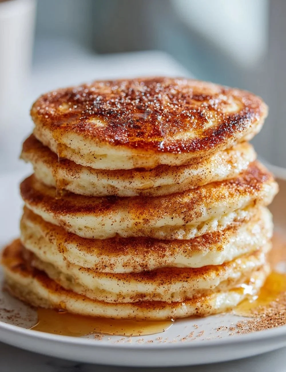 Delicious Spanish churro pancakes topped with cinnamon and sugar