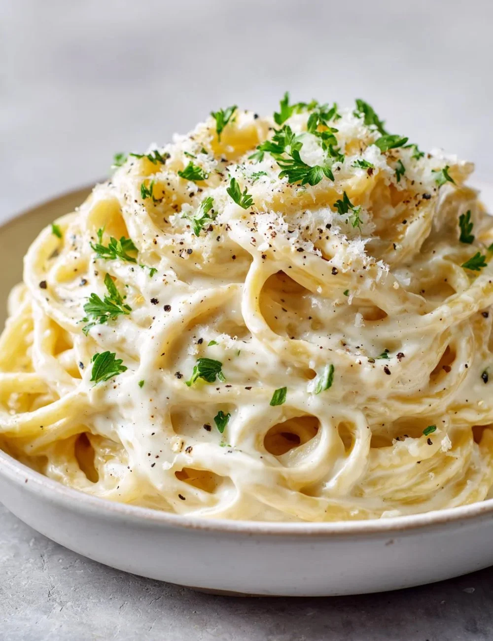 Creamy Cottage Cheese Alfredo sauce atop pasta dish with fresh herbs