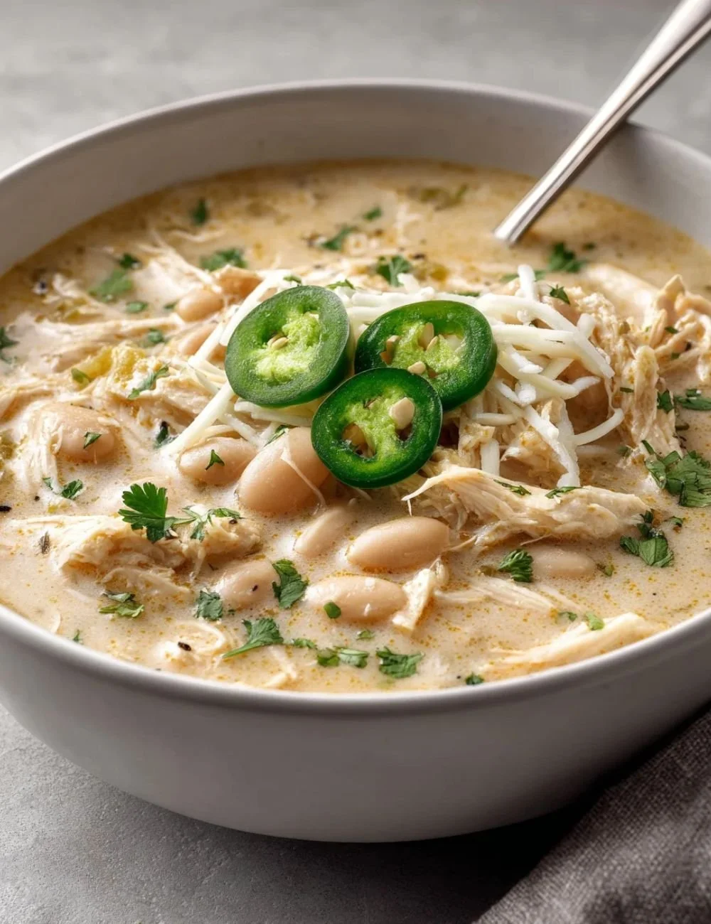 Delicious bowl of white chicken chili topped with cilantro and lime