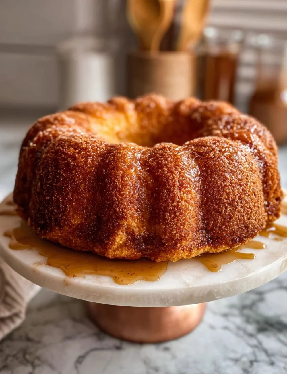 Delicious homemade Apple Cider Cake with a slice showing moist texture and apple chunks.