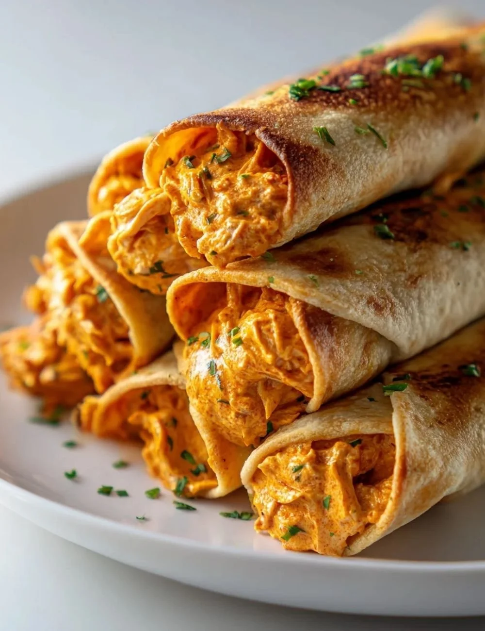Buffalo Chickpea Taquitos served with dipping sauce on a plate