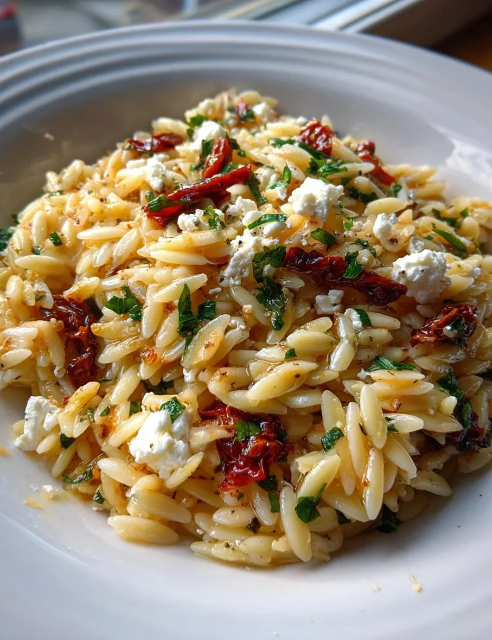 Delicious homemade orzo pasta salad with fresh vegetables and herbs.