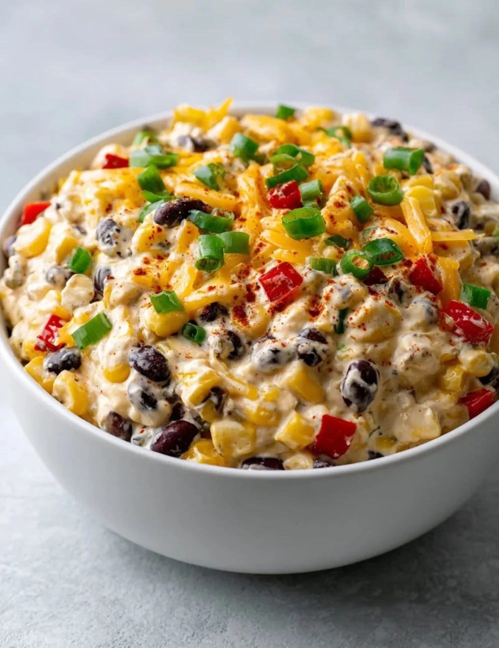 Creamy Cowboy Corn Dip served in a bowl with tortilla chips.