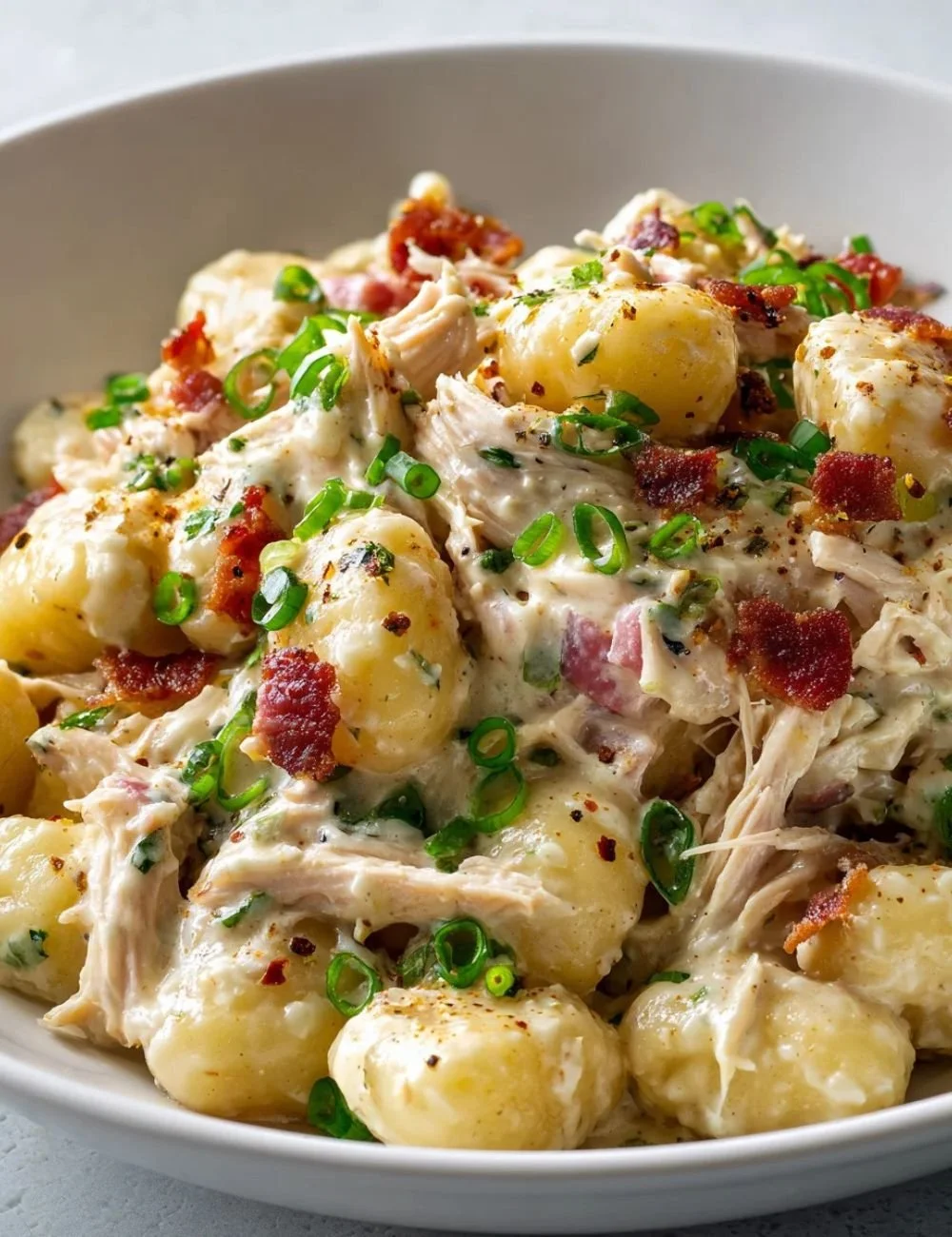 Creamy crack chicken gnocchi served in a bowl with fresh herbs