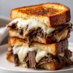 Delicious French Dip Grilled Cheese sandwich with melted cheese and juicy beef