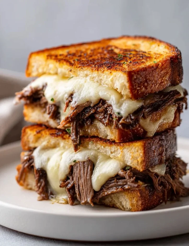 Delicious French Dip Grilled Cheese sandwich with melted cheese and juicy beef