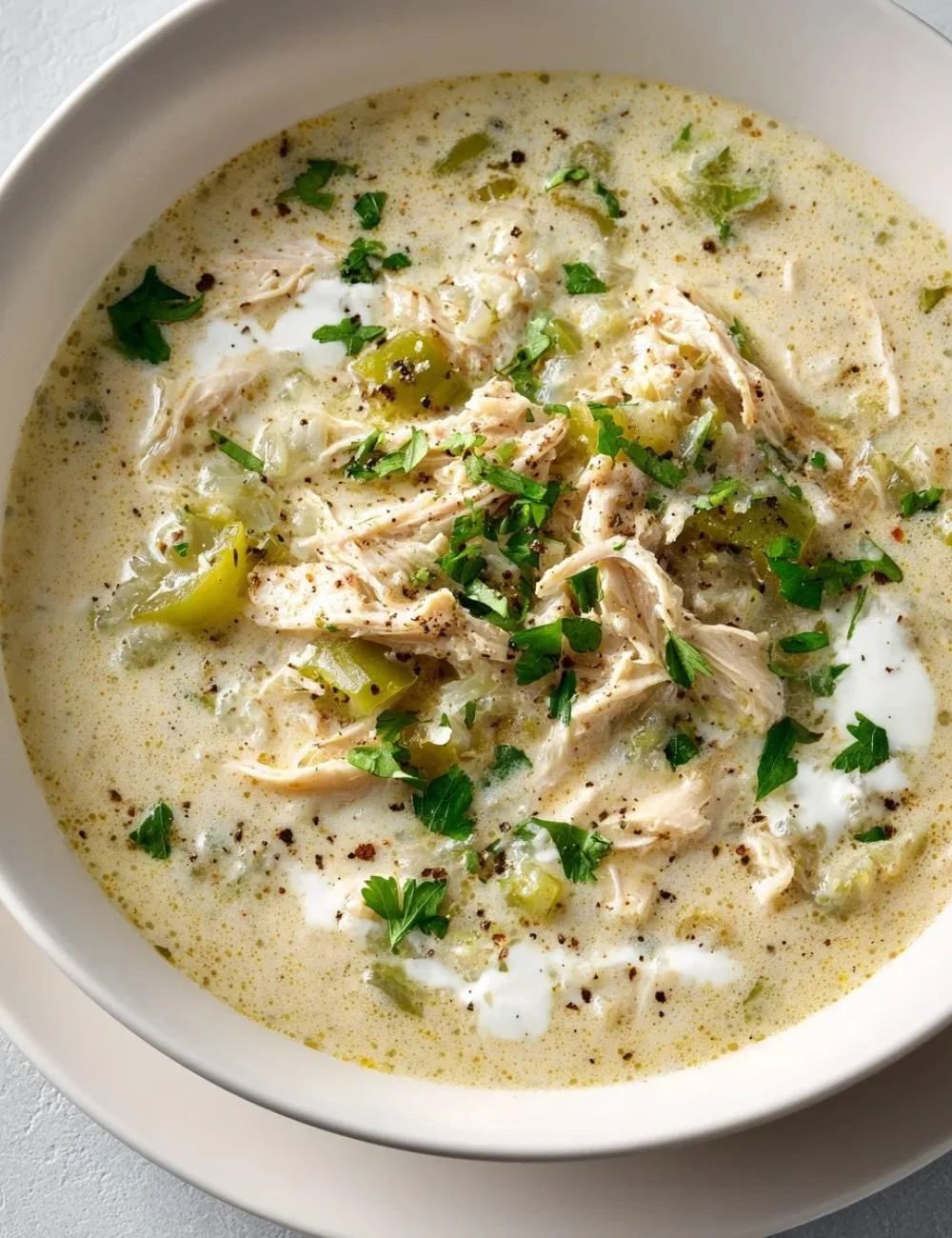 Bowl of Keto White Chicken Chili topped with cilantro and avocado
