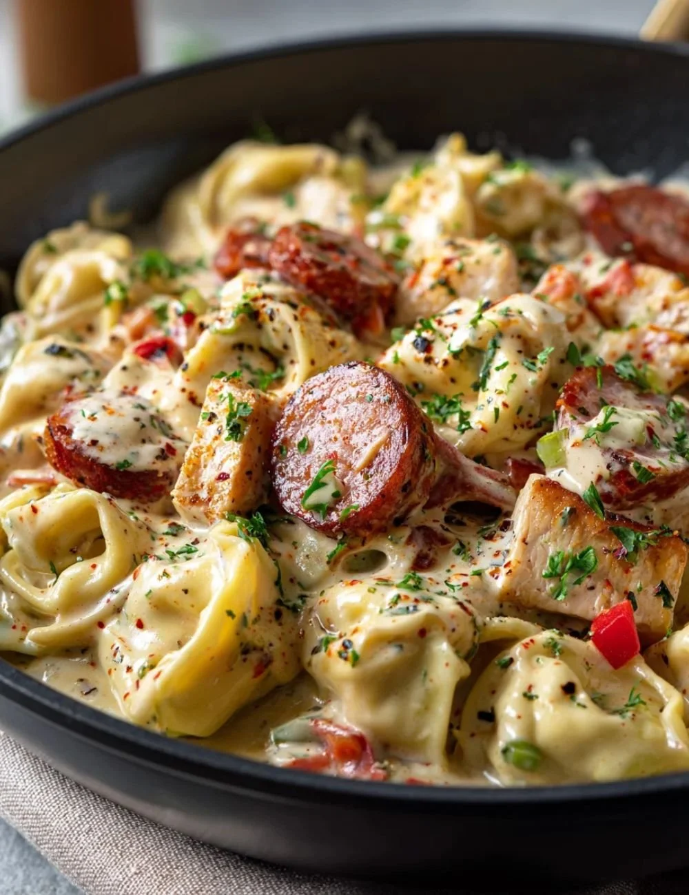 Loaded Cajun Alfredo Tortellini Skillet with creamy sauce and spices
