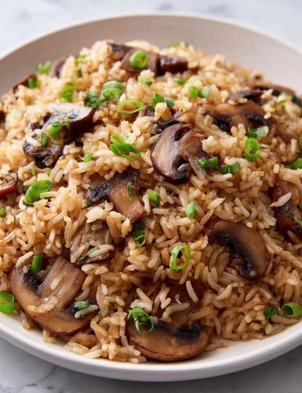 Delicious mushroom rice served in a bowl, garnished with herbs.