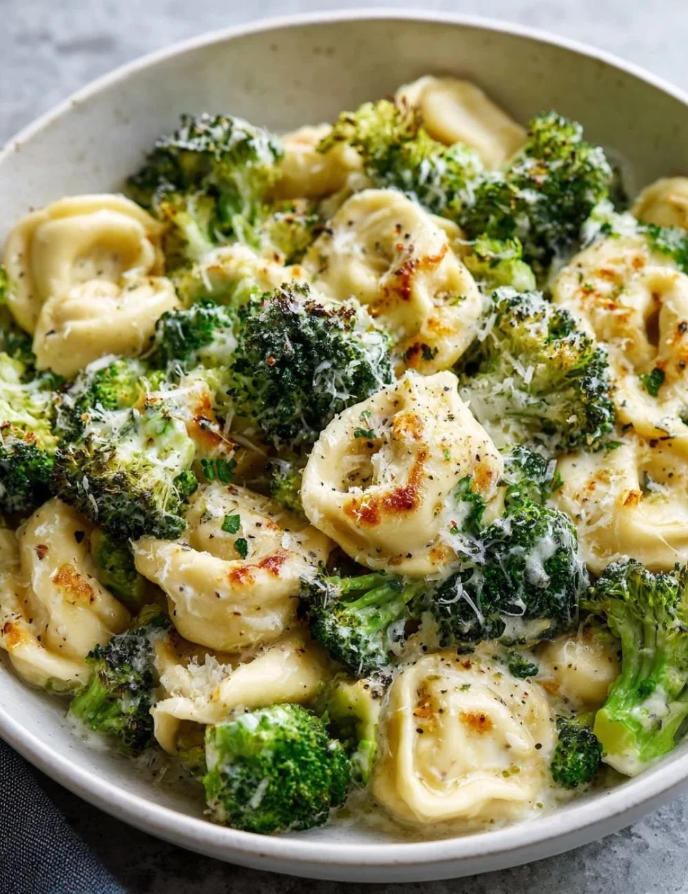 Sheet Pan Broccoli Tortellini Bake fresh from the oven, served in a colorful dish.