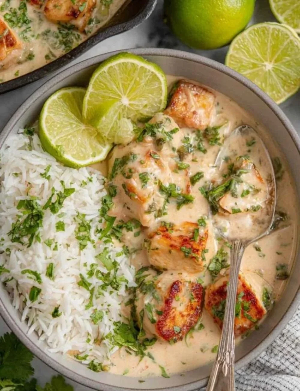 Coconut Lime Tofu dish served with fresh herbs and lime wedges