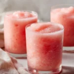 Creamy coconut watermelon smoothie slush in a glass with fresh fruit