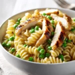 Creamy spring pasta with chicken and peas in a bowl
