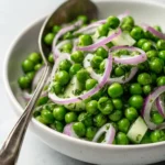 Crisp vinegar-based pea salad with fresh ingredients in a bowl