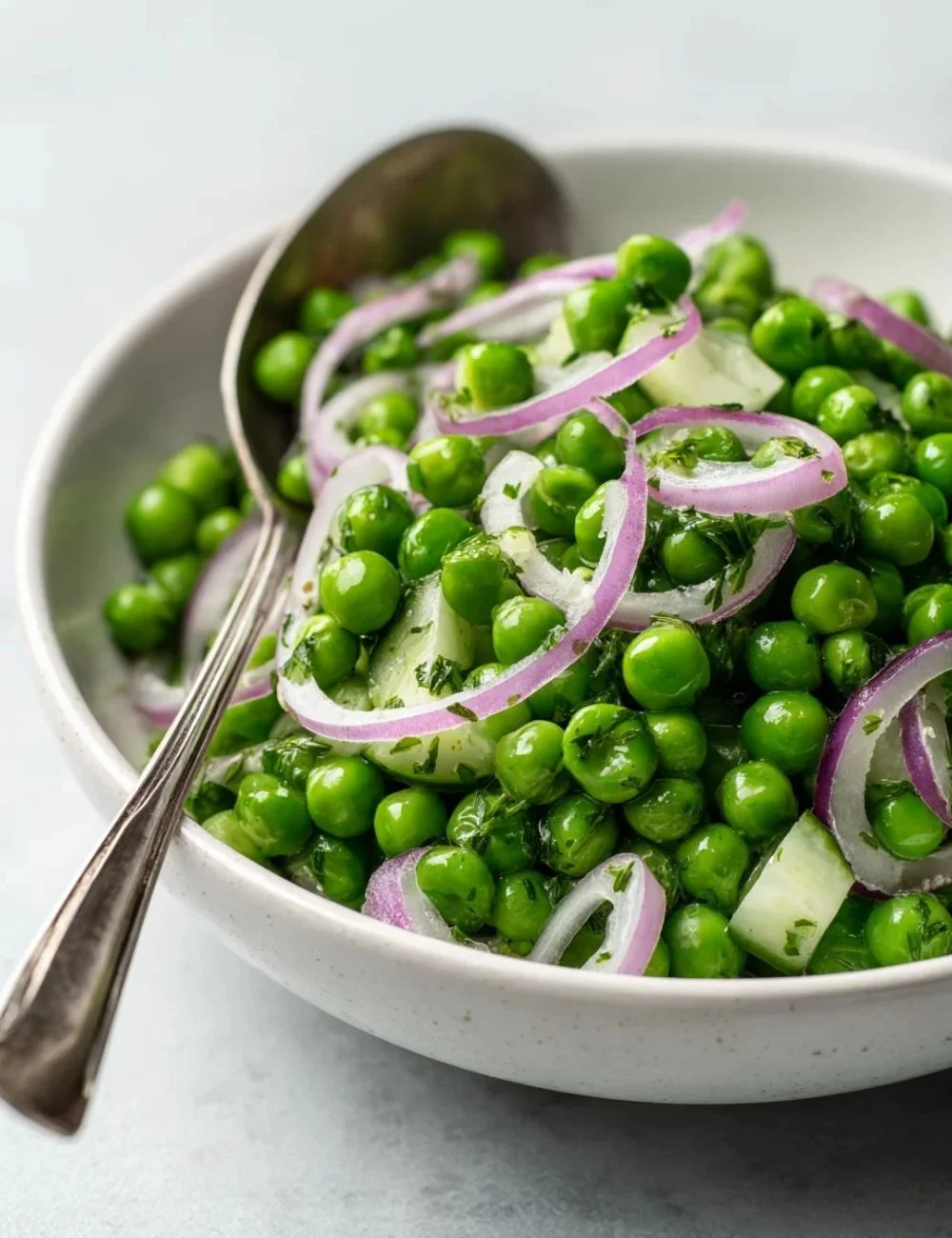 Crisp vinegar-based pea salad with fresh ingredients in a bowl