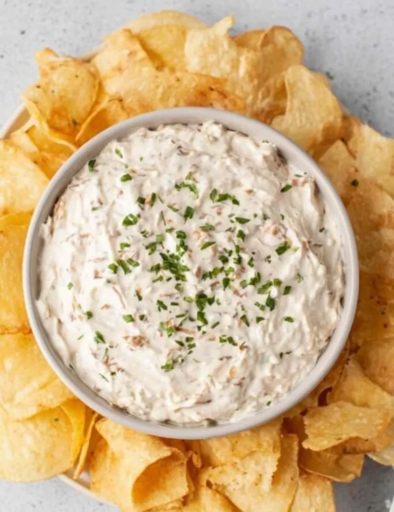 Healthy Greek Yogurt Onion Dip served in a bowl with fresh vegetables.