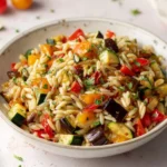 Delicious roasted vegetable orzo dish with colorful vegetables and herbs
