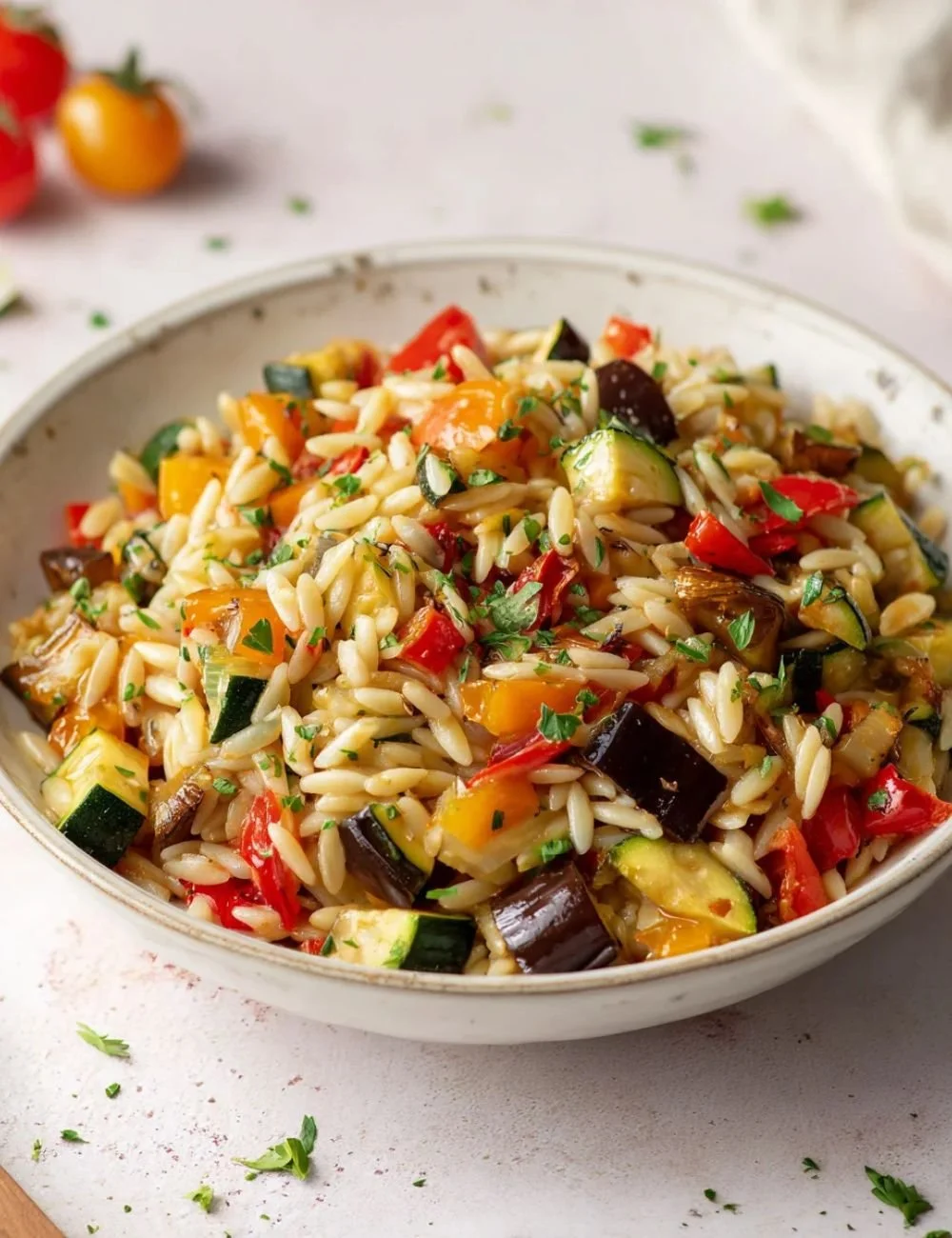 Delicious roasted vegetable orzo dish with colorful vegetables and herbs