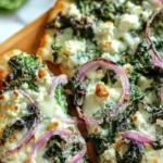 Delicious Spinach Feta Pizza served on a wooden board with fresh toppings.