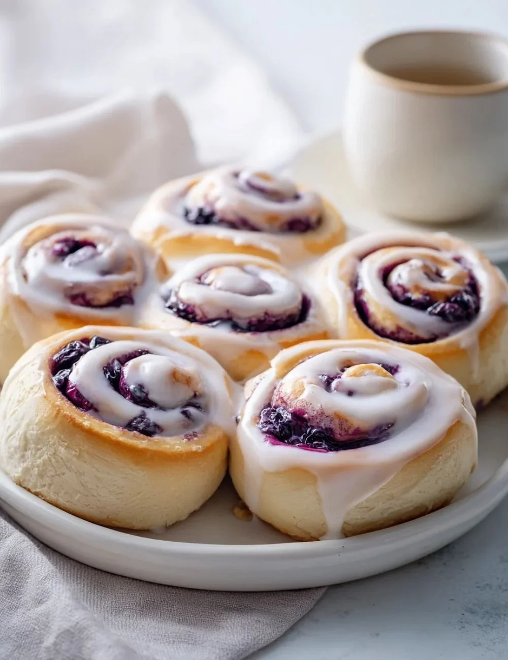 Delicious tangy sourdough blueberry cinnamon rolls fresh out of the oven.
