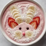 Colorful and healthy Bunny Smoothie Bowl topped with fruits and nuts.