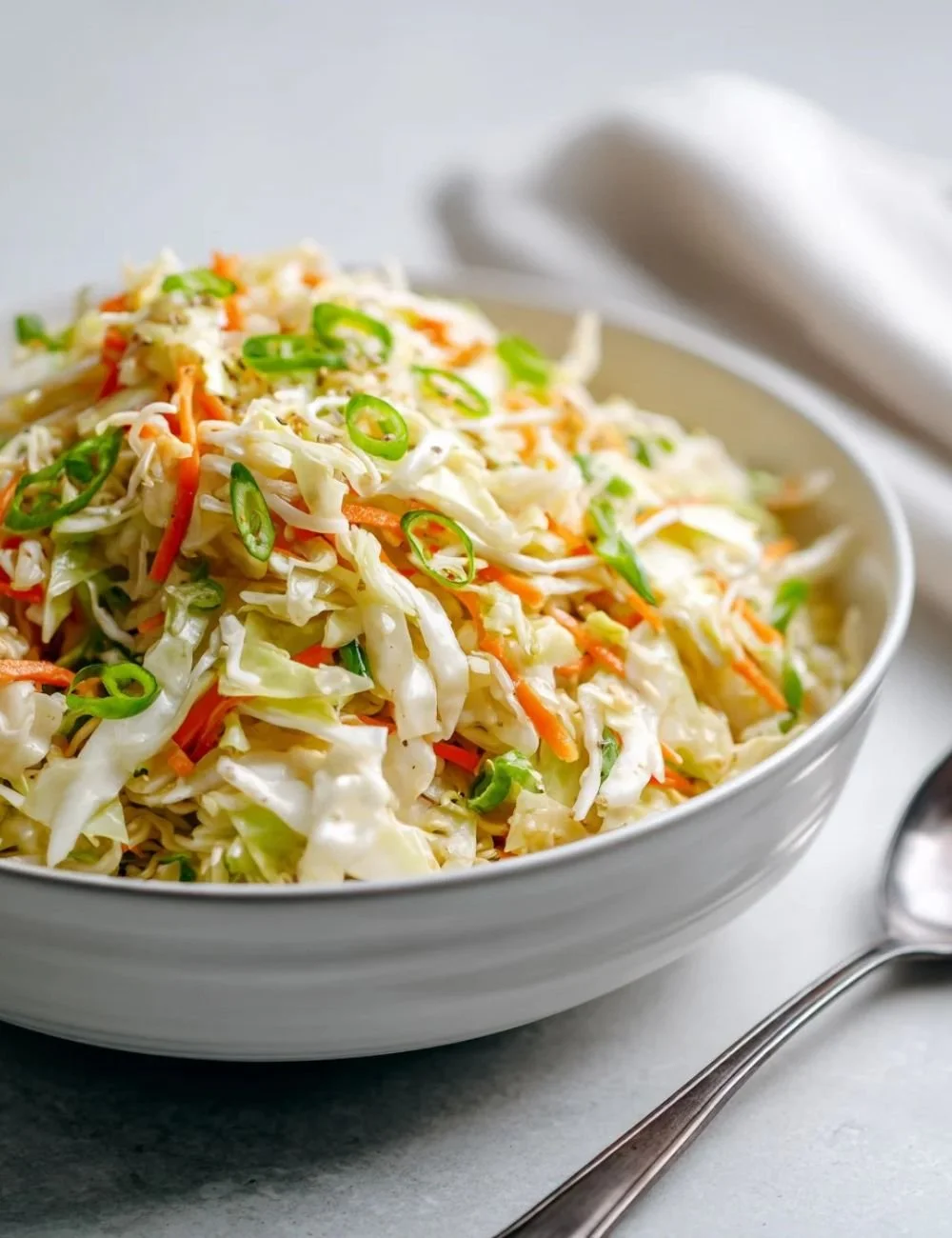 Delicious cabbage ramen noodle salad in a bowl with fresh vegetables