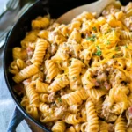 Cheeseburger pasta dish served in a bowl with ground beef, cheese, and pasta.