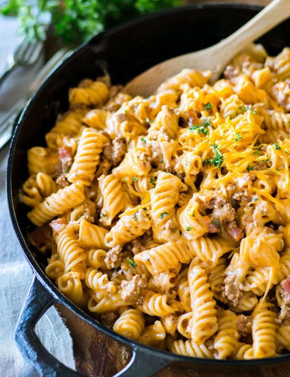 Cheeseburger pasta dish served in a bowl with ground beef, cheese, and pasta.