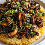 Crispy miso mushroom rice topped with fresh herbs and sesame seeds