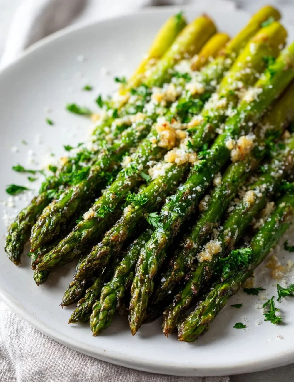 Easy garlic roasted asparagus with Parmesan served on a plate