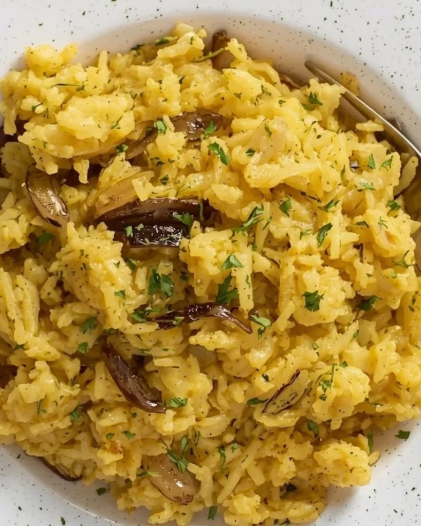 Delicious Golden Onion Butter Rice garnished with fresh herbs.