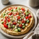 Greek salad hummus board with fresh ingredients and colorful presentation