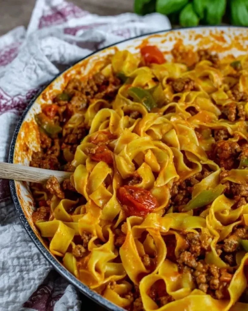 Plate of Italian Drunken Noodles garnished with fresh basil.