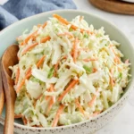 Bowl of KFC Coleslaw featuring fresh cabbage and carrots in creamy dressing