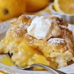 Delicious slice of Magic Lemon Cobbler dessert with a golden crust and lemon filling.