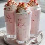 Delicious Strawberry Cheesecake Milkshake topped with whipped cream and strawberries.